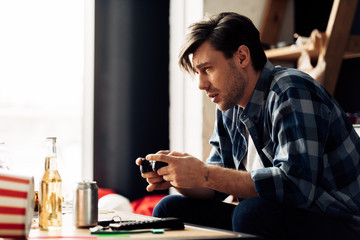 Fototapeta premium sleepy man playing video game at home