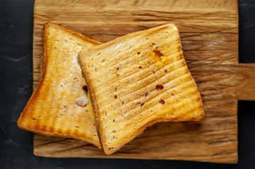 two sandwiches on a wood background