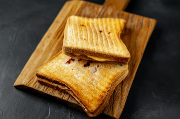 two sandwiches on a wood background
