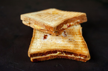 two sandwiches on a wood background