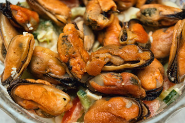 salad with fried mussels on a plate, selective focus, close