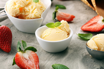 Vanilla ice cream scoop with fresh strawberries and icecream cones