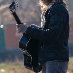 Guy plays guitar in park