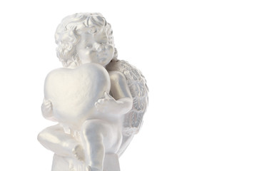 Cherub statue isolated on white background. Angel holds the heart. Love