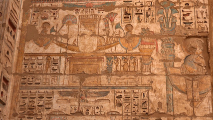 photography Ancient Egyptian carvings of people and hieroglyphics on the exterior walls of an...
