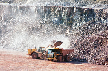 eath mover loading stones on a dumper truck