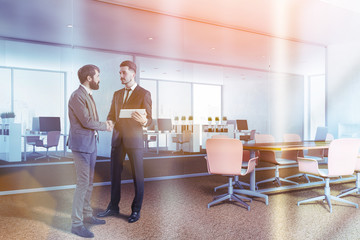 People in corner of white meeting room