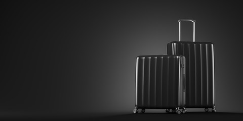 Two black suitcases on black