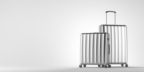 Two silver suitcases on white
