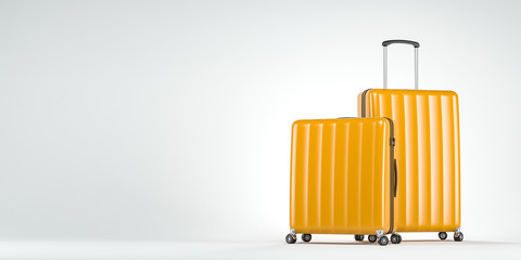 Two yellow suitcases on white