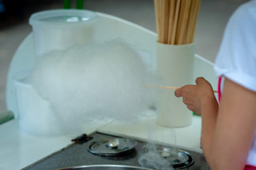 Woman is preparing candy floss in the park - Image