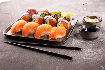 close up of sashimi sushi set with chopsticks and soy - sushi roll with salmon and sushi roll with smoked eel