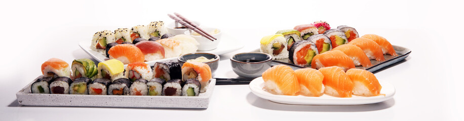 Naklejka na ściany i meble close up of sashimi sushi set with chopsticks and soy - sushi roll with salmon and sushi roll with smoked eel