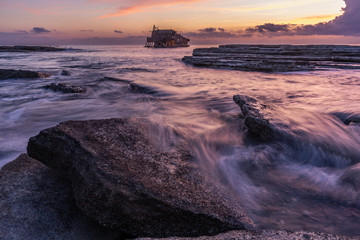 Sunset with a view on Akrotiri Shipwreck on the Mediterranean coast in Cyprus