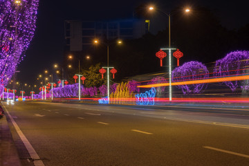 Highway with Colorful Lights in Spring Festival.abstract image of blur motion of cars on the city road at night,Modern urban architecture in Chongqing, China