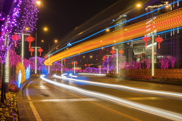 Highway with Colorful Lights in Spring Festival.abstract image of blur motion of cars on the city road at night,Modern urban architecture in Chongqing, China