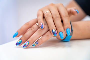 lot of color gloss manicure hand has different blotches in a light background © skif