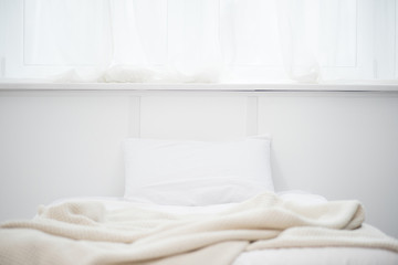 selective focus of empty bed with white pillow and blanket
