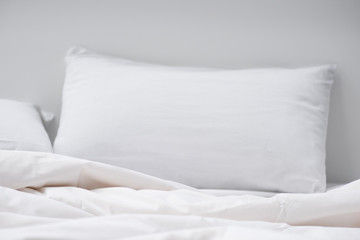 selective focus of bed with white pillow and blanket