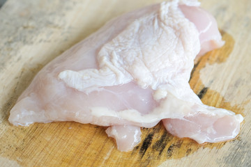 Fresh chicken breasts placed on the wood