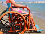 little girl in a wheelchair with wheels modified to move on the