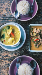 Thai Green Curry and Panang Curry With Jasmine Rice Served on a Distressed Wooden Table Outdoors