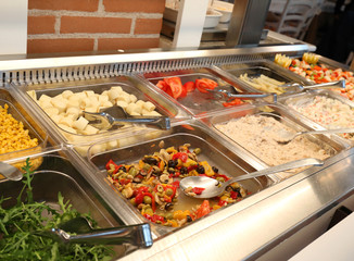 self service restaurant with many raw and cooked foods