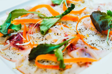 Fresh Sliced raw beef meat with leaf lettuce on the table