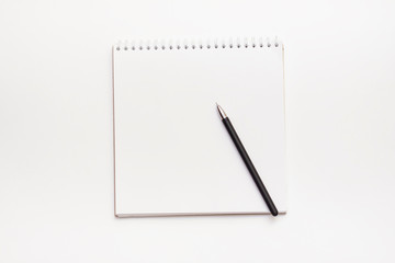 Spiral blank notepad and black pen on white background.Top view