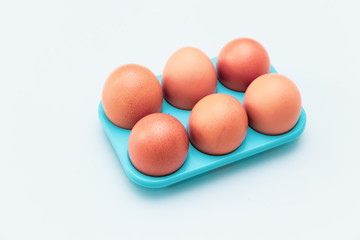 the pack of eggs in plastic packaging with white background