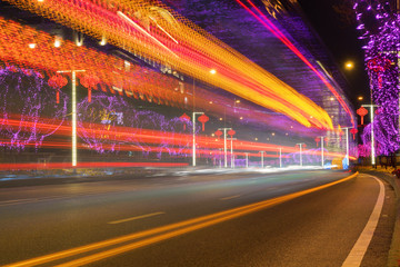Fototapeta na wymiar Highway with Colorful Lights in Spring Festival.abstract image of blur motion of cars on the city road at night,Modern urban architecture in Chongqing, China