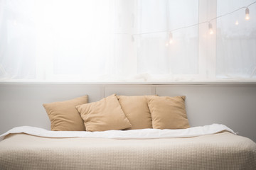 bedroom with brown pillows and white blanket on bed