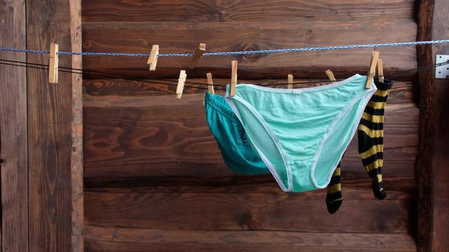 Beautiful underwear dries outside. Women's wet pants on the street dry