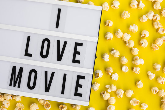 I love movie text on light box with pop corn on pastel color background