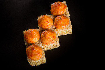 top view baked roll with salmon, green onion and cheese sauce