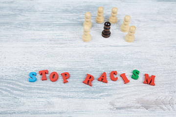 No to racism in colored letters on a gray wooden background