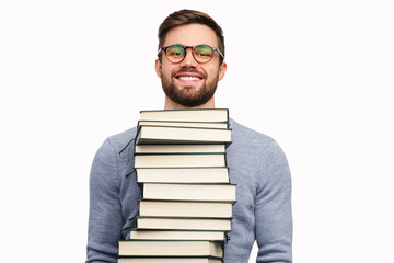 Smiling student with pile of books