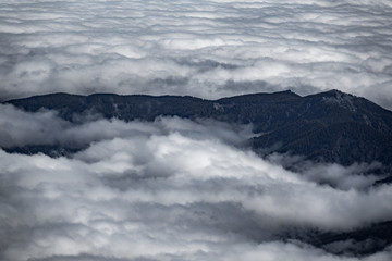 Fototapeta premium Top view of mountains and clouds