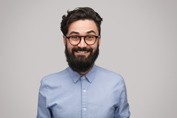Handsome thrilled man in eyeglasses