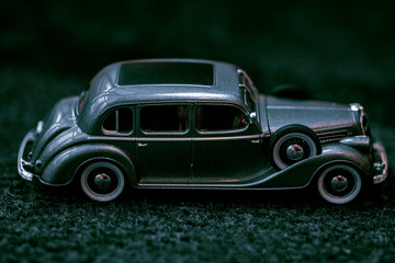 Dark grey vintage car . Retro car's close up.Retro car on a dark background. Car close-up.