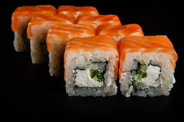 closeup philadelphia roll sushi with smoked salmon, cucumber, and cream cheese