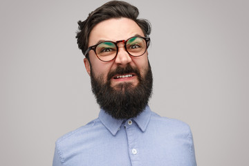Obraz premium Angry bearded man in glasses