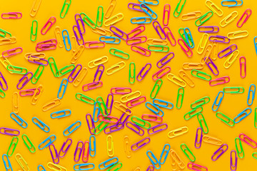 Paper color clip notebook on yellow background. Flat lay.