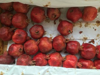 juicy fresh pomegranates in a wooden box