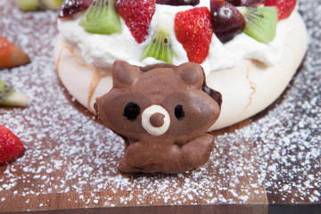 Obraz premium Meringue dessert on brown oak dishes on white scenes.