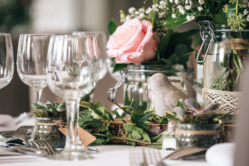 Table decoration with floral and pink pastel compositions