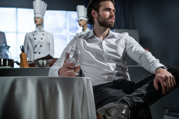 A man in a restaurant drinking cognac