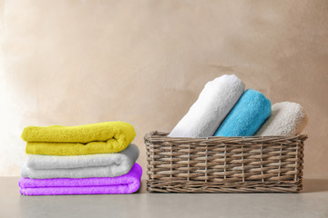 Basket and stack of clean towels on table