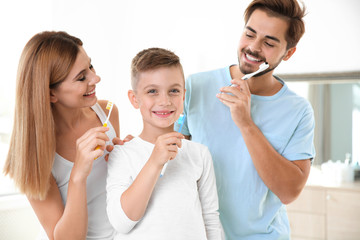 Happy family with toothbrushes in bathroom. Personal hygiene