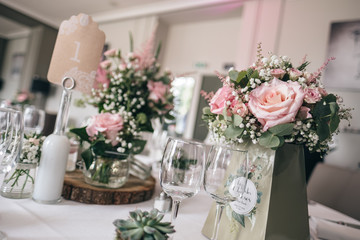 Table decoration with floral and pink pastel compositions